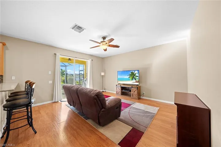Living room featuring light wood-type flooring and ceiling fan