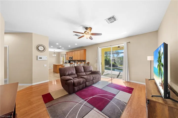 Living room featuring ceiling fan, light wood-type flooring, and recessed lighting