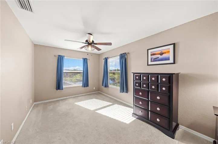Bedroom with a ceiling fan and carpet flooring