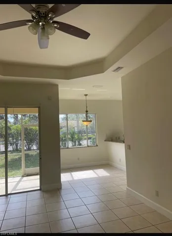 Spare room featuring light tile patterned flooring and ceiling fan