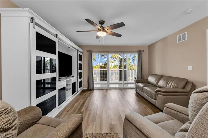 Living area featuring light wood-type flooring and a ceiling fan