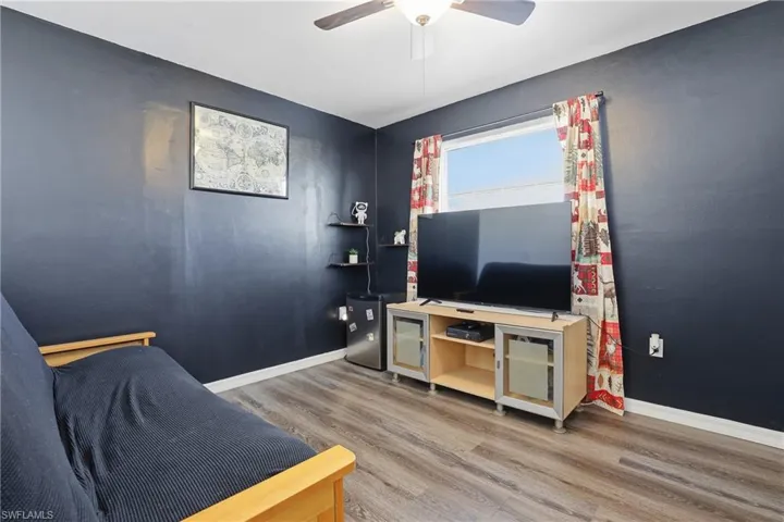 Living room with light wood finished floors and a ceiling fan