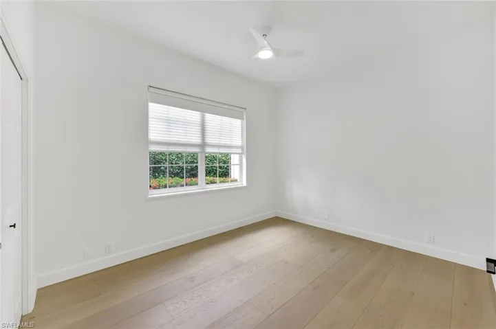 Bedroom with wood-type flooring and a ceiling fan