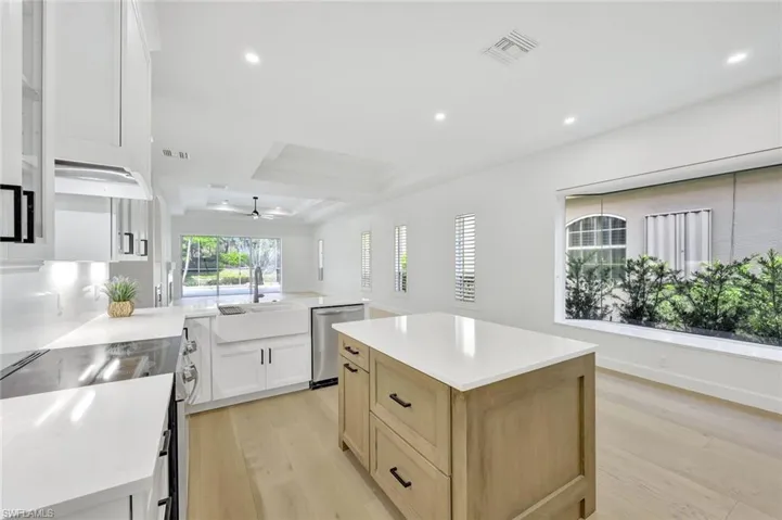 Kitchen with new appliances with stainless steel finishes, light wood-type flooring, ceiling fan, recessed lighting, and light countertops