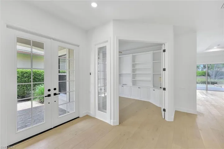 Doorway to outside featuring french doors, light wood-style flooring, and recessed lighting