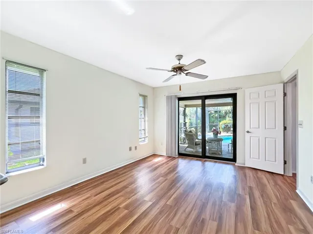 Unfurnished room with dark hardwood / wood-style floors and ceiling fan