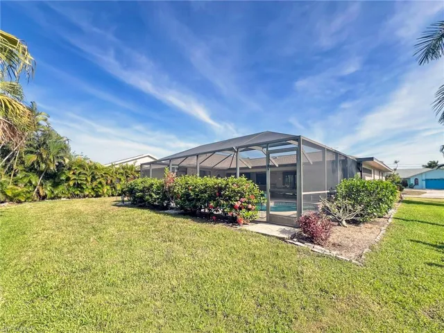 View of yard with a lanai and a swimming pool
