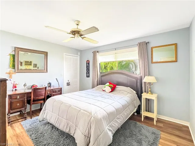 Bedroom featuring a closet, hardwood / wood-style flooring, and ceiling fan