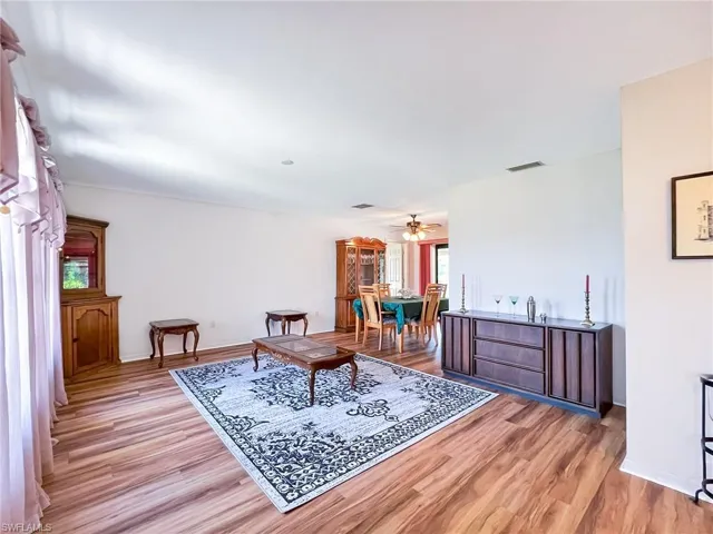 Living area featuring ceiling fan and light wood-type flooring
