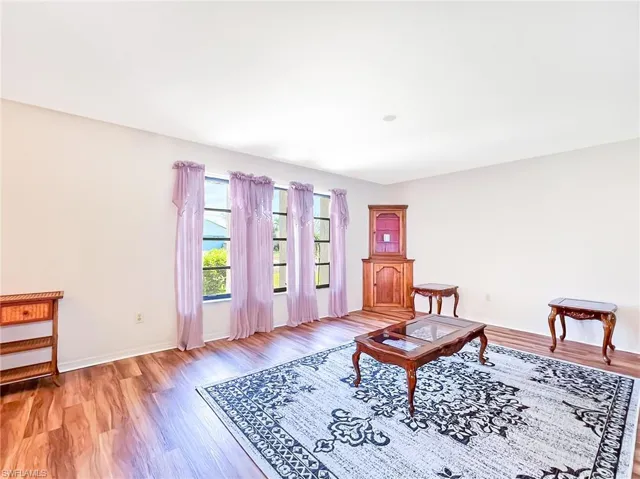 Living area with light hardwood / wood-style flooring