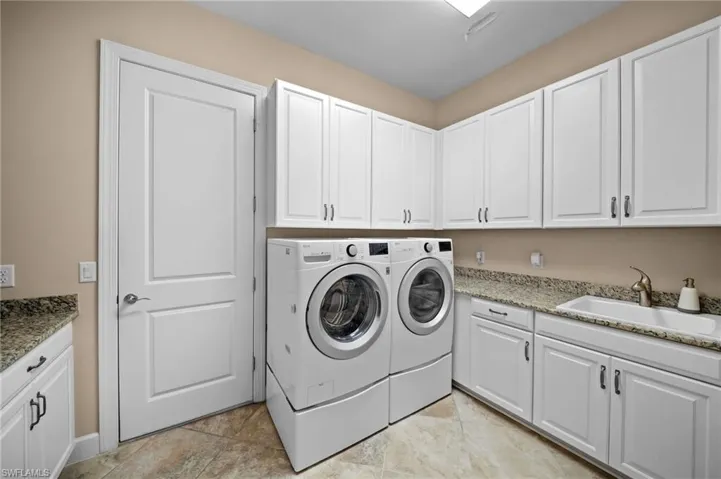 Laundry area with cabinet space and separate washer and dryer