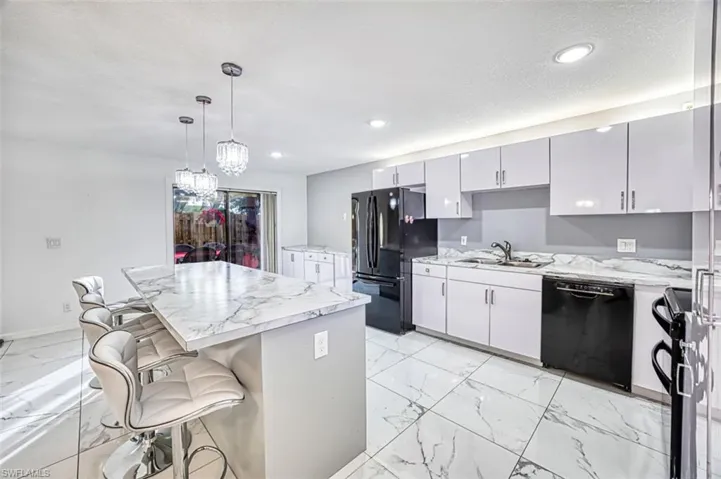 KITCHEN overlooking LANAI/COURTYARD with LARGE CENTER ISLAND for DINING and ENTERTAINING