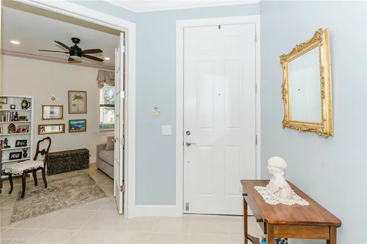Foyer entrance featuring ornamental molding, light tile patterned floors, ceiling fan, and recessed lighting
