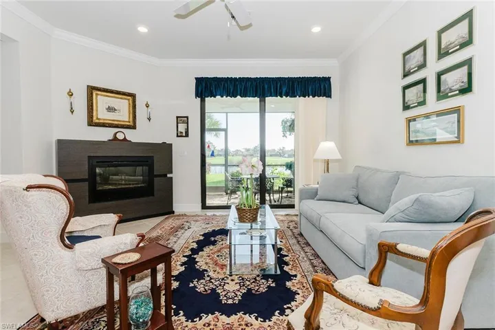 Living room to lanai and open to kitchen as well.  Crown molding, recessed lighting, and ceiling fan