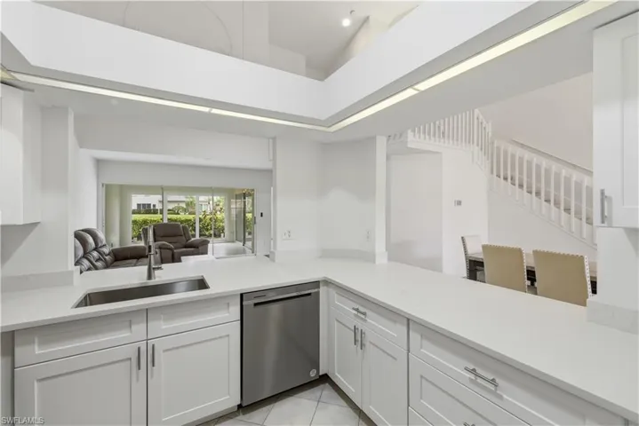 Bright kitchen featuring white shaker cabinetry, stainless steel appliances, and light-toned countertops