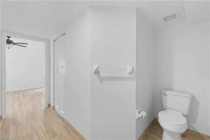 Neutral white walls complementing light wood-finish flooring