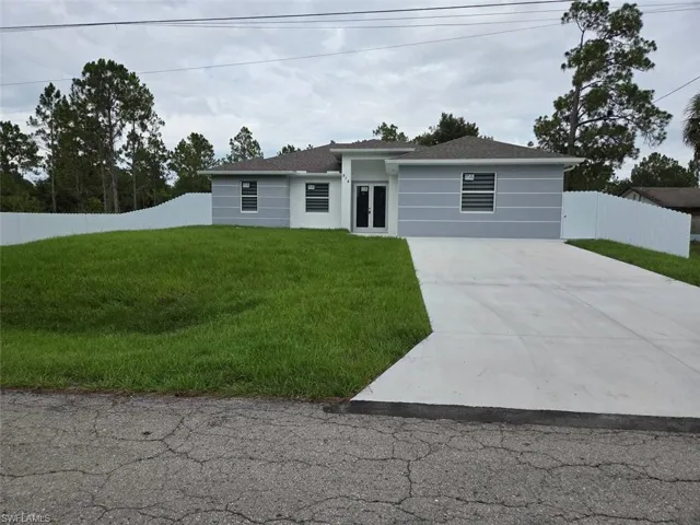 Contemporary single-story residence featuring a light gray and white exterior