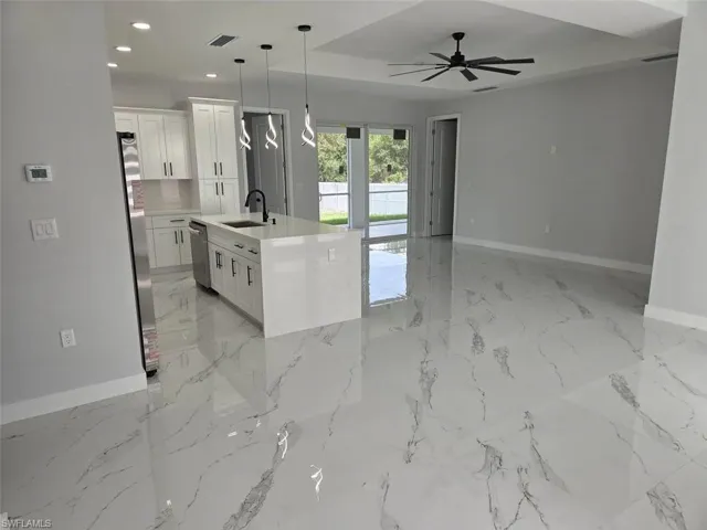 Open-concept living space with large format tile flooring throughout