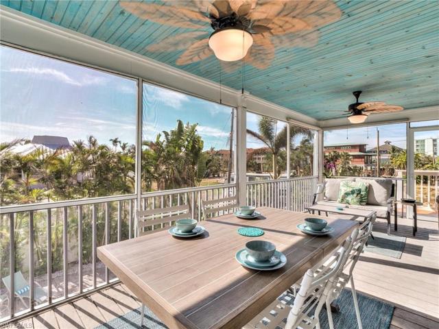 Large screened balcony that spans the rear of the home featuring beadboard ceiling and composite decking.
