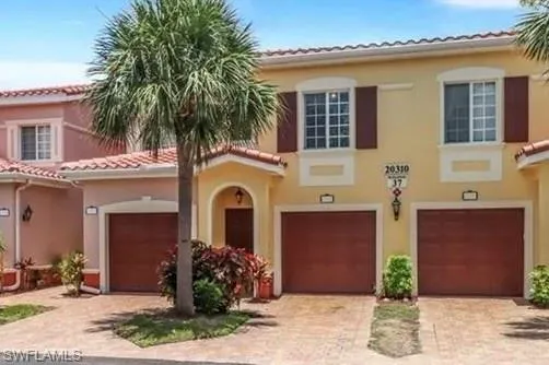 Mediterranean / spanish-style home with a tiled roof, stucco siding, decorative driveway, and a garage