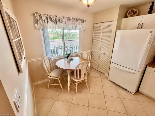 Dining space featuring light tile patterned floors and baseboards