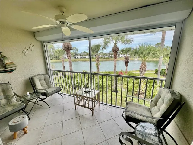 Sunroom / solarium featuring plenty of natural light, a ceiling fan, and a water view