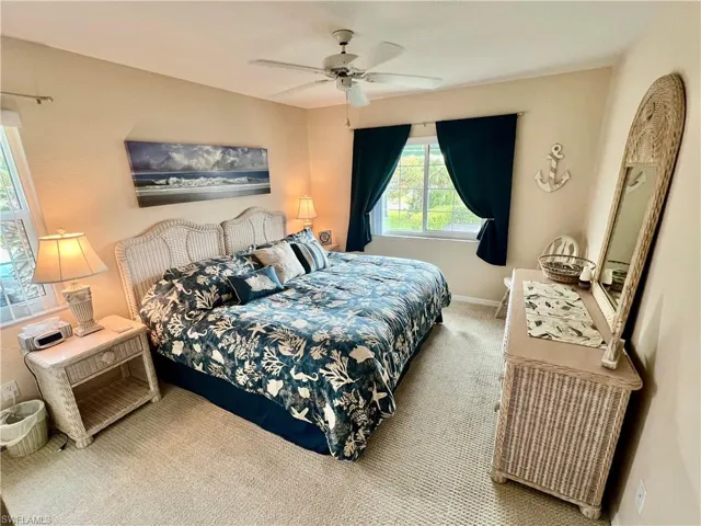 Bedroom featuring a ceiling fan, carpet, and baseboards