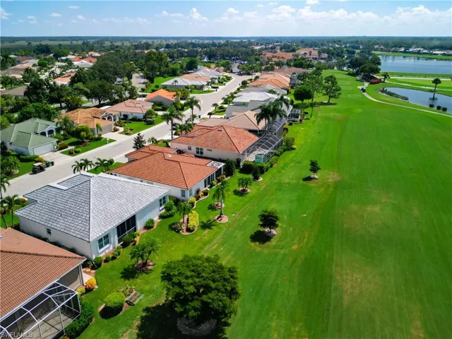Birds eye view of property with golf course/water view