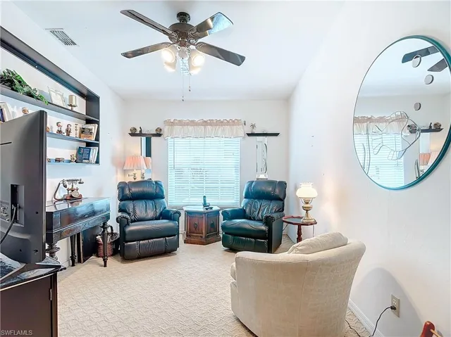 Den/3rd bedroom with closing door ceiling fan and light colored carpet