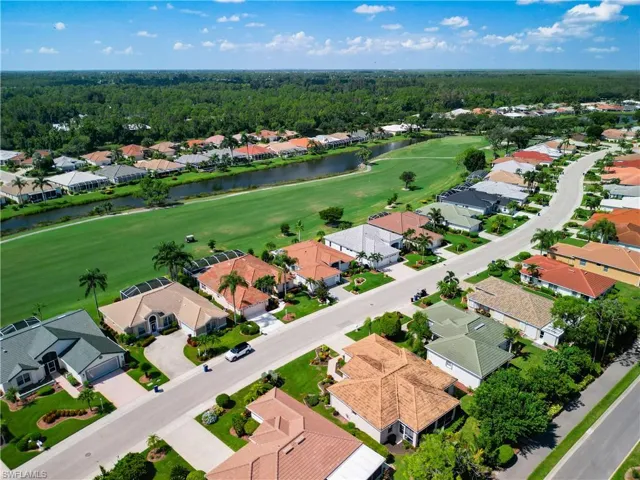 Drone / aerial view featuring golf course and a water view