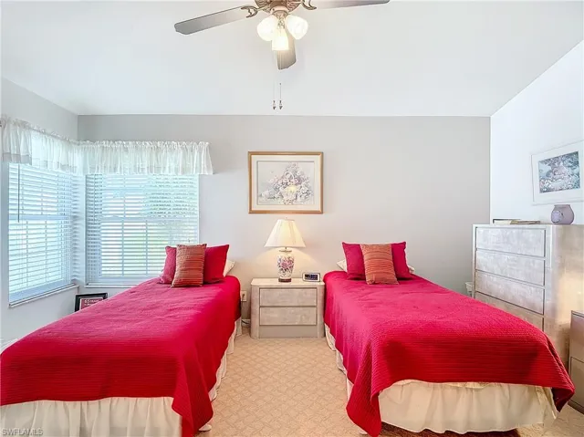 Bedroom featuring ceiling fan and light colored carpet