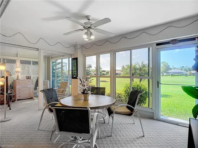 Florida room with sliding openable windows and  ceiling fan. View of golf course.
