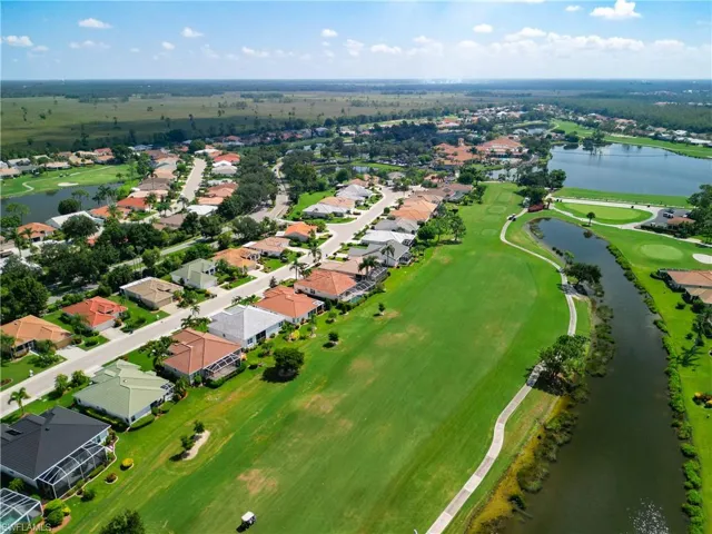 Drone / aerial view with golf course/water view