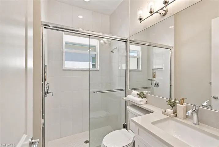 on-suite guest bathroom with glass enclosure - some furniture and decor virtually stagedshower