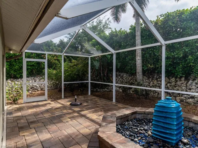 View of patio featuring glass enclosure