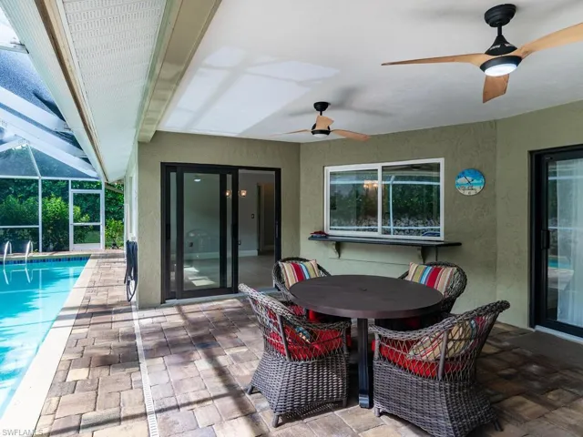 View of patio / terrace featuring a lanai and ceiling fan