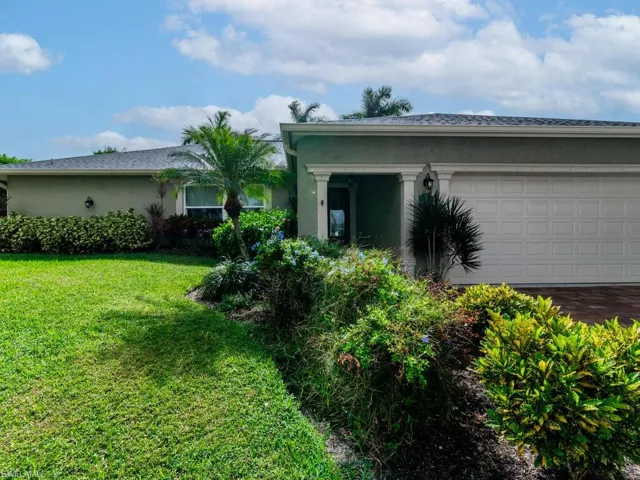 View of property exterior with a garage and a yard
