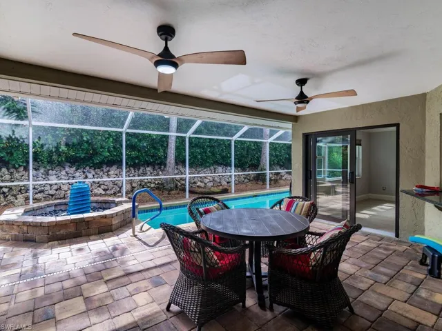 View of patio with a lanai and ceiling fan