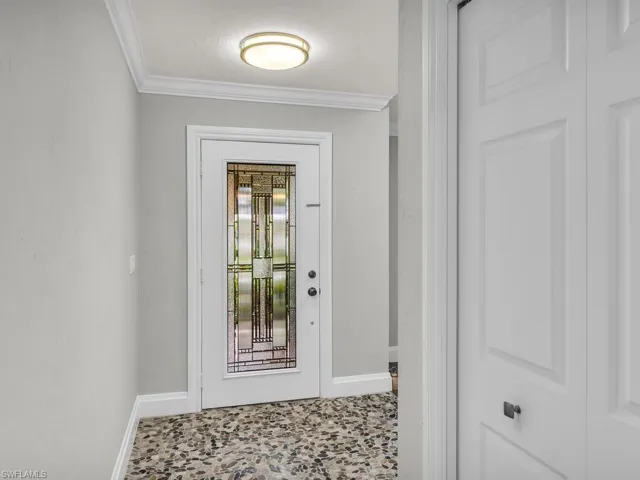 Doorway to outside with ornamental molding