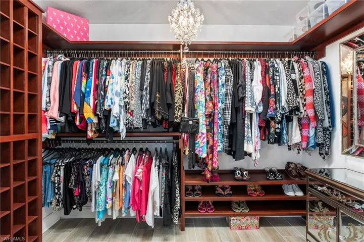 Spacious closet featuring a chandelier