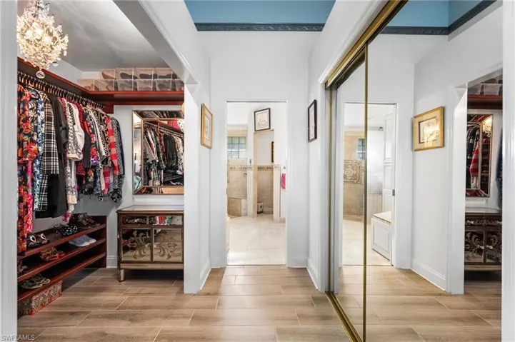 Walk in closet featuring an inviting chandelier