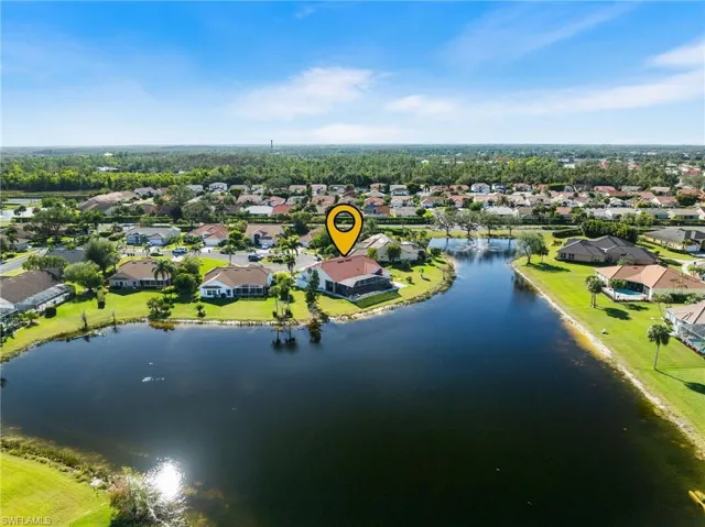 Birds eye view of property with a water view