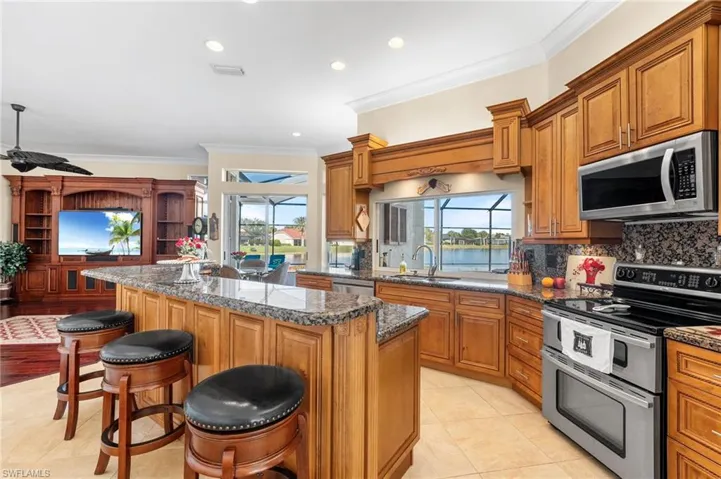 Kitchen featuring sink, stainless steel appliances, plenty of natural light, a breakfast bar area, and a center island with sink