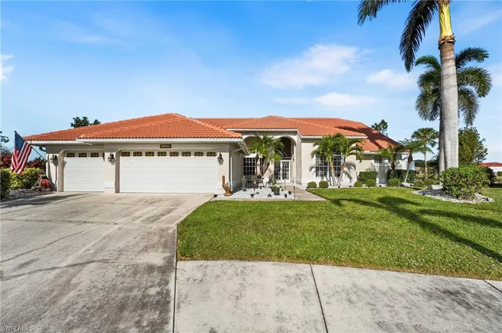 Mediterranean / spanish-style home featuring a front yard and a garage