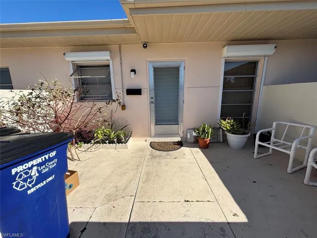 View of exterior entry with a patio area