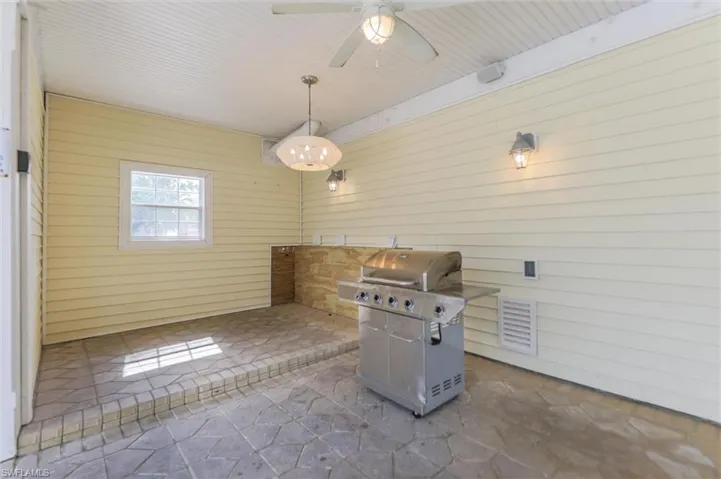 View of patio featuring a grill and ceiling fan