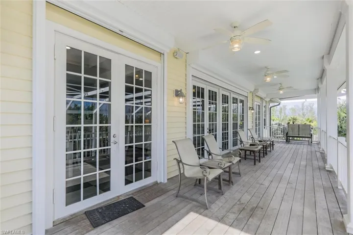 Wooden deck featuring french doors and a ceiling fan