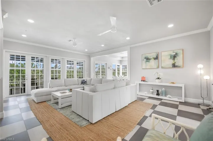 Living area featuring ornamental molding, light floors, recessed lighting, and a ceiling fan