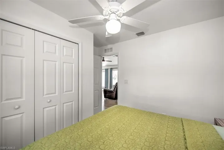 Unfurnished bedroom with a ceiling fan, a closet, and visible vents