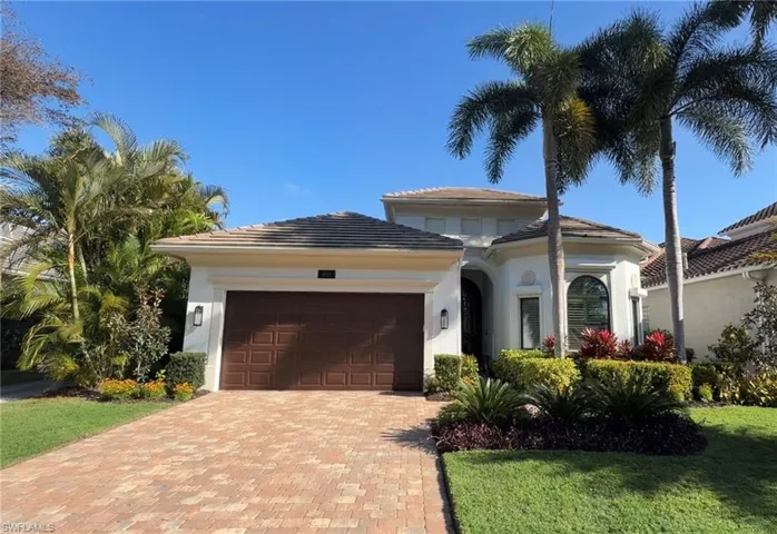View of front of home featuring a garage, decorative driveway, stucco siding, a front lawn, and a tiled roof